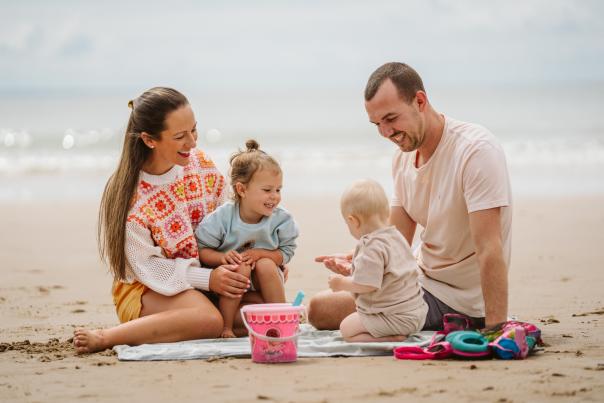 A family enjoying playing on the beach
