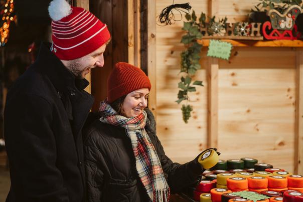 A couple looking at cheese at the Christmas Market
