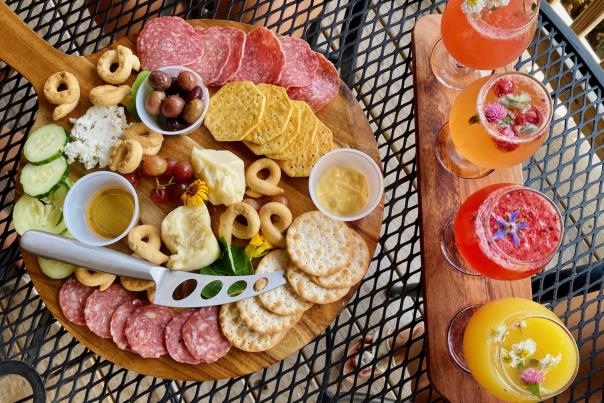 a charcueterie board and mimosa flight board on a table