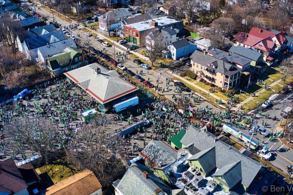 Drone shot of Colemans Irish Pub and big crowds of People for Green Beer Sunday