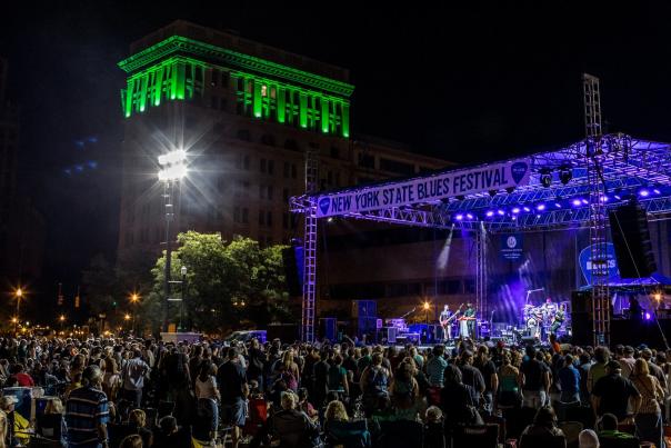 Night-time Photo of Syracuse Blues Fest Stage with People Crowded Around