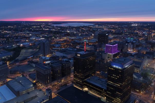 Skyline of Syracuse showing downtown and lake at dusk