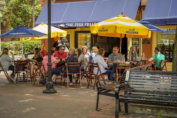 People dining outdoors at the Fish Friar Syracuse
