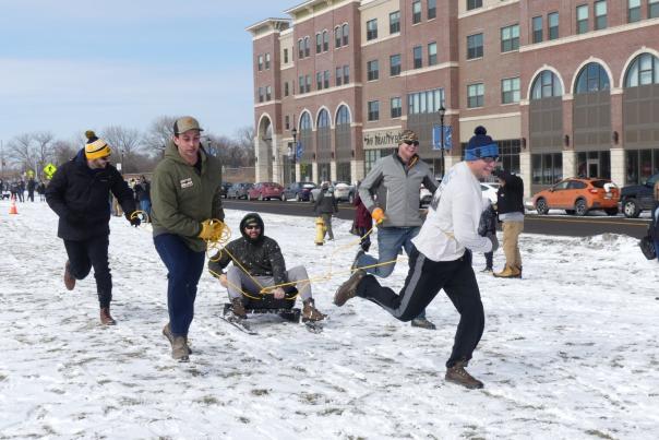 human dog sledding at winterfest