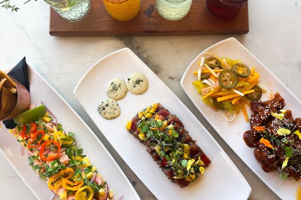 Close up of several dishes and cocktails