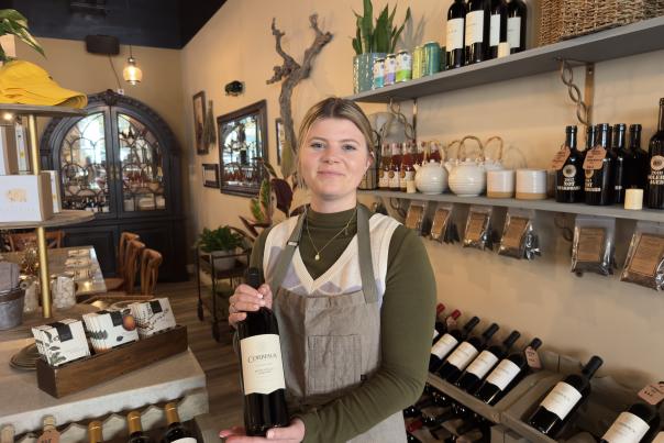 A woman holding a bottle of wine