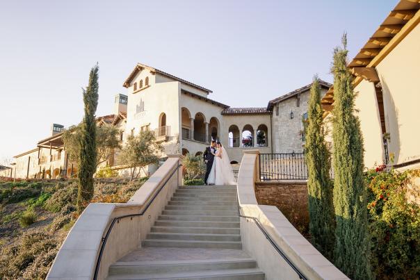 Bride and groom at the top of the stairs at Europa Village