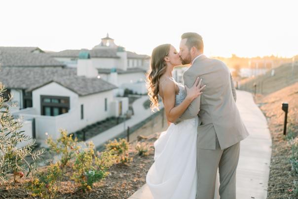 A bride and groom kiss outside Europe Village