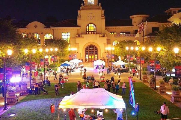 Overhead shot of the Temecula Sunset market at night, with vendor tents and performers around the lawn