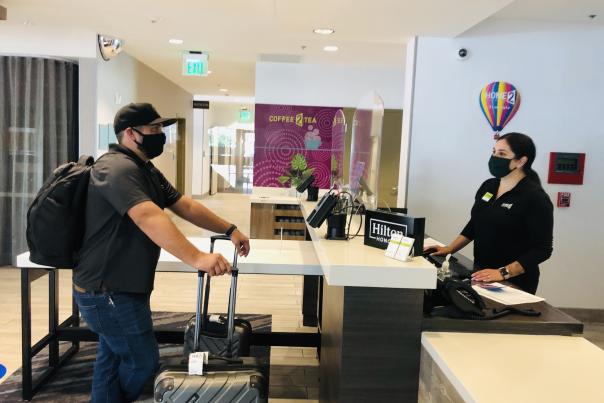 A man checks into a hotel lobby