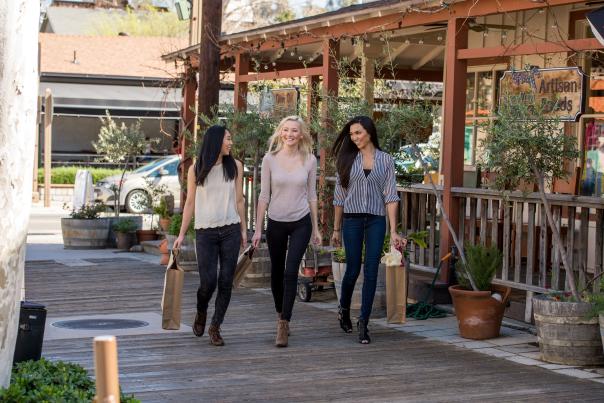 Three women walkin down Old Town with shopping bags