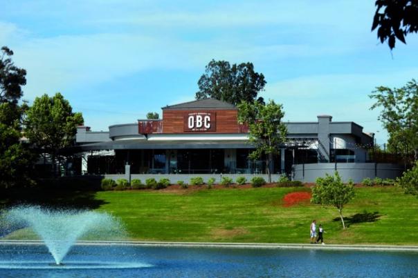 Exterior shot of the OBC with a lake in the front