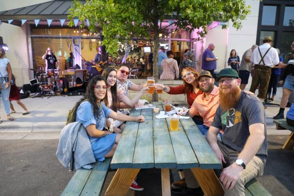 Group of people enjoying First Friday on 1st Street