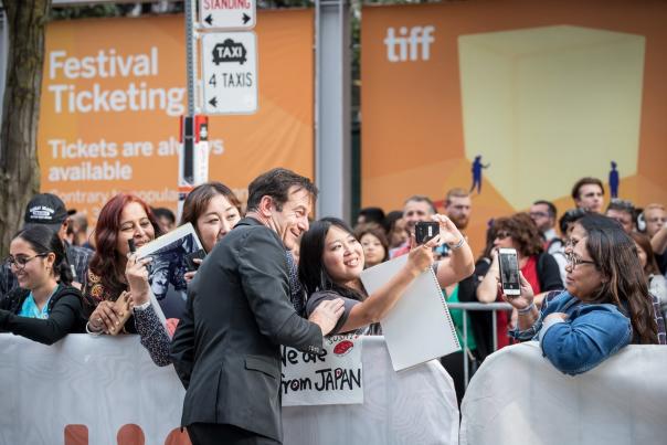 TIFF Festival crowds, girl taking photo with a celebrity