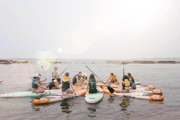 Oceah Oceah SUP X Yoga Class, group of women sitting on paddle boards in a circle on the lake
