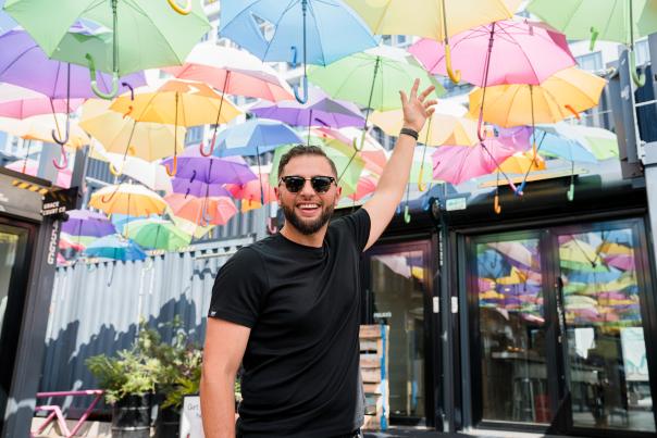 Abdullah Snobar at Stackt under colorful umbrella instaltion