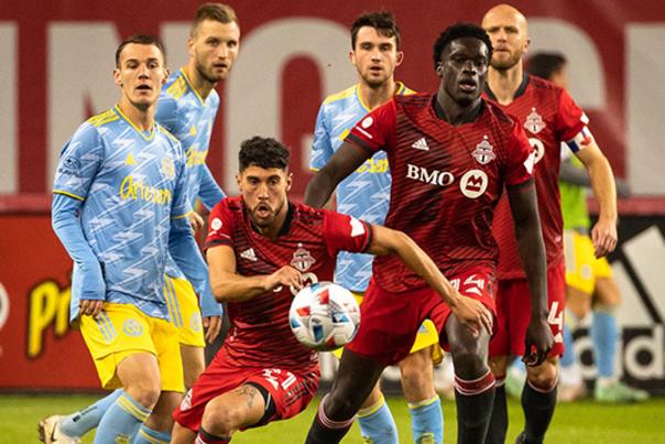 Players from both teams move toward the ball during a game between the Toronto FC and the Philadelphia Union