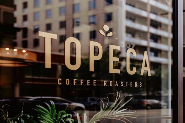 The window outside of a Topeca Coffee Roasters location.