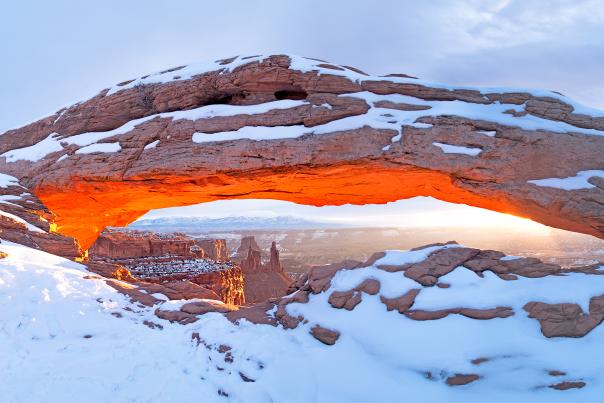 Snow covered Mesa Arch in Canyonlands National Park in the wintertime