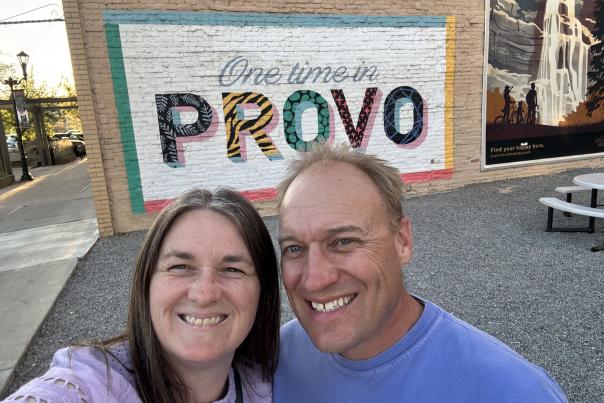 Couple taking a selfie in front of the One Time in Provo mural downtown