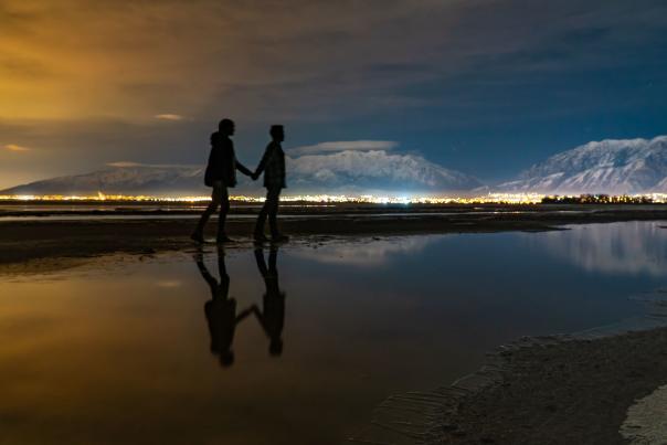 Couple walking on lake shore Credit Wyatt Peterson