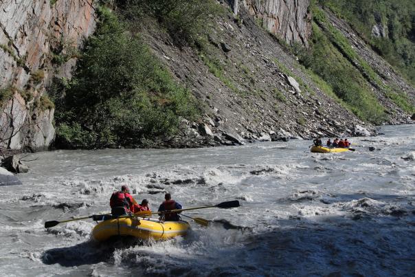 rafters in a river in a canyon