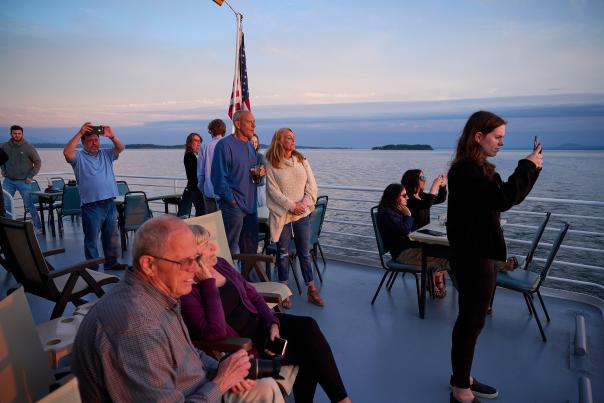 people taking photos of the sunset over Lake Champlain on the Spirit of Ethan Allen