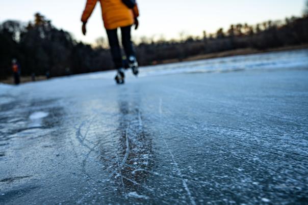Skater glides across the ice on a winter day in Burlington, Vermont