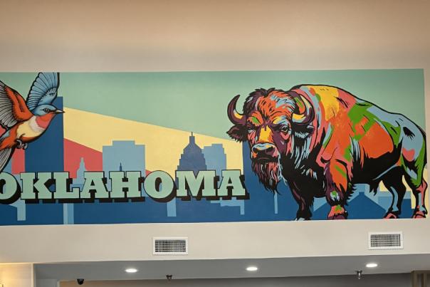 mural of a buffalo and scissortail flycatcher with text that reads "Oklahoma" on a wall
