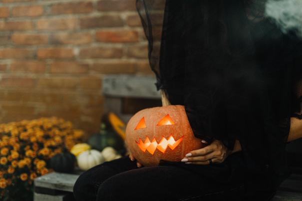 Halloween Witch Holding Pumpkin