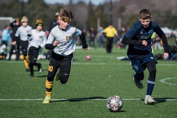 Boys playing soccer at MC United tournament