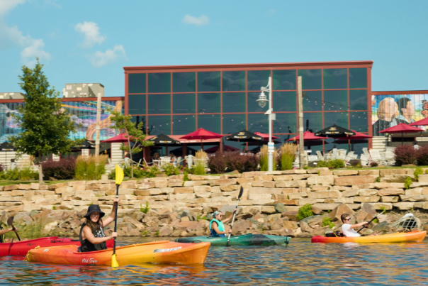 Friends paddling on kayaks near downtown Wausau