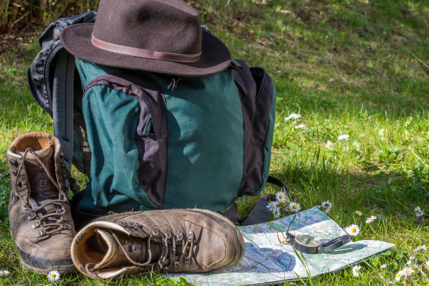 7 Spring Hikes Blog Cover - Backpack, Boots, Hat, and Map in Field
