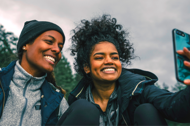 Two Girls Taking a Selfie Together in Hiking Clothes