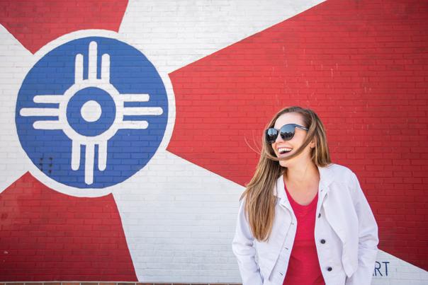 Woman in front of Wichita Flag mural