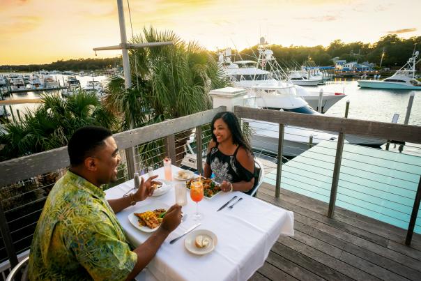 Couple dines by the marina in Wrightsville Beach
