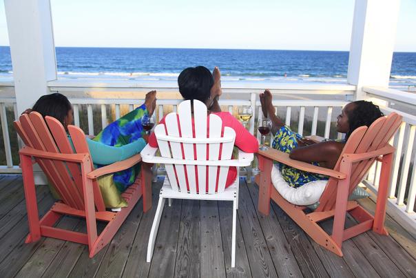 Three women relaxing on a deck in Wrightsville Beach