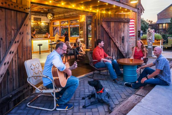 People Playing Guitar And Enjoying A Beer Outside Of A Brewery In Wilmington, DE
