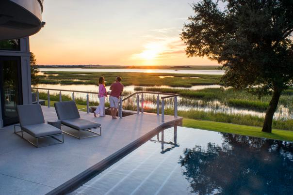 A couple watching the sunset from an outdoor deck in Wilmington, NC