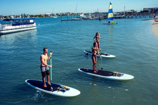 A group doing Stand up paddleboarding in Wrightsville Beach