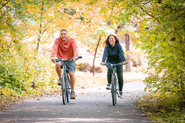 Couple bike riding on trail.