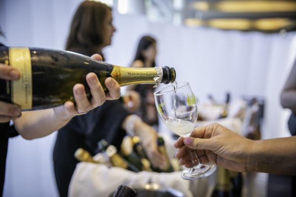 Person pouring wine into glass during Wine and Food Week in The Woodlands, Texas