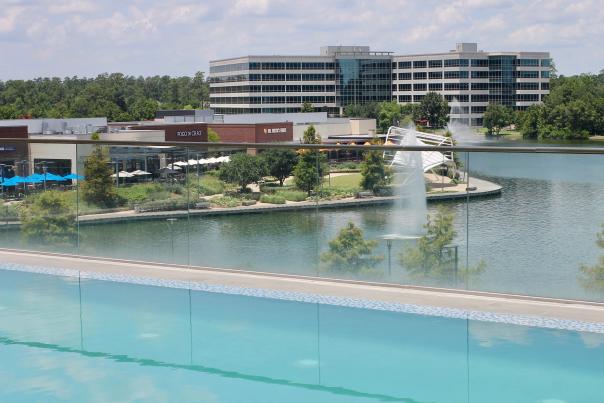 View from infinity pool at Embassy Suites overlooking Restaurant Row and Lake Woodlands at Hughes Landing