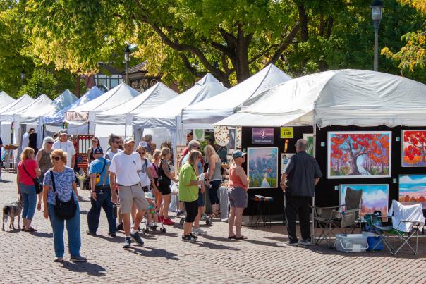 White tents dotting the Woodstock Square filled with original artwork and people walking