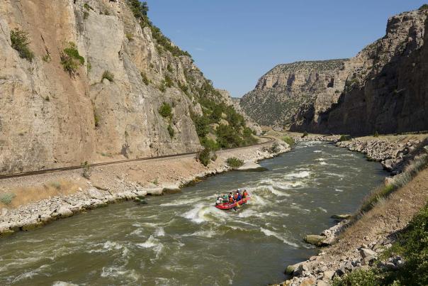 Group of people rafting through whitewater rapids on a river in Fremont County, near Thermopolis, Wyoming.