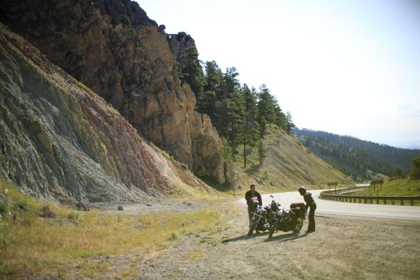 A couple on the side of the Cloud Peak Scenic Byway with their motorcycles