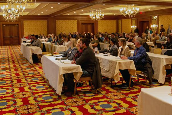 Conference attendees listening to a presentor