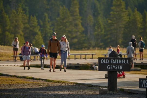 Family walking the boardwalk trails around Old Faithful