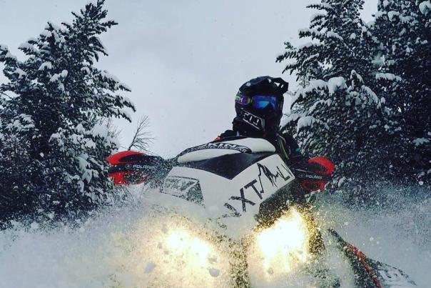 A snowmobiler kicks up snow in Yellowstone National Park.