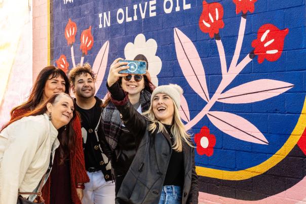 friends taking a selfie in front of a mural at Mural Park in the Royal Square District of Downtown York